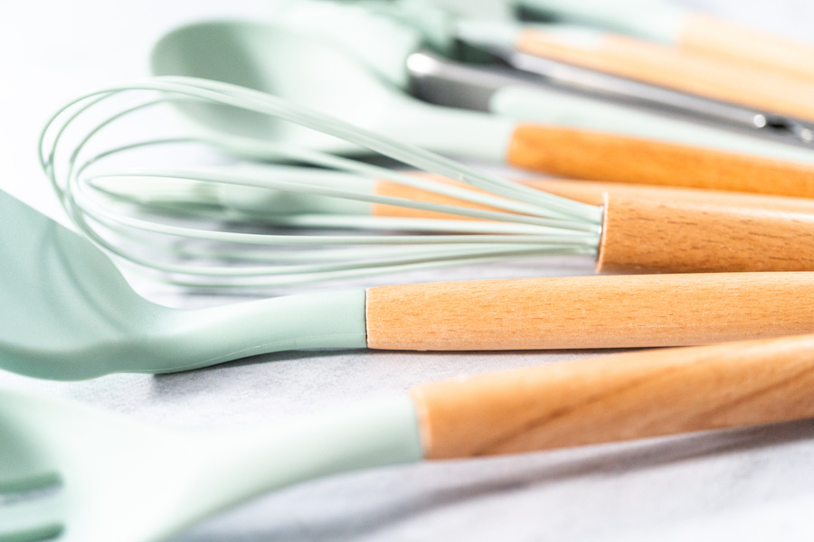 Silicone cooking utensils with wooden handle.